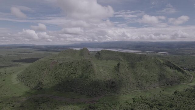 Aerial drone stock footage of a wide circle shot of Sleeping warrior hill crater in the great rift valley in Naivasha, Kenya