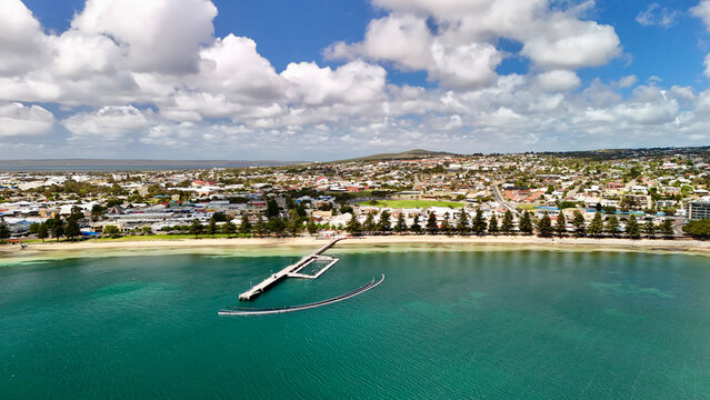 Port Lincoln, South Australia &ndash; 4K aerial drone view of coastal city, jetty, turquoise bay, beachfront, marina, suburban houses, residential estates and Eyre Peninsula shoreline