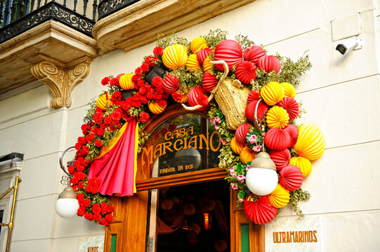 Casa Marciano (House Marciano), a bar and restaurant in Seville, decorated with paper lanterns and red flowers for the April Fair. Seville Fair. Cheerful, festive, and colorful celebration in Seville.