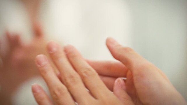 Girl gently massages a nourishing cuticle oil into her skin, meticulously caring for the delicate area around her nails. This regular manicure routine maintains healthy, well-groomed hands and nails