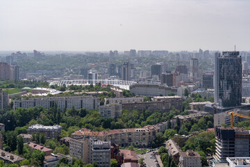 Obraz premium Aerial cityscape of Kyiv Ukraine with sports stadium and residential high rises, urban skyline panorama view