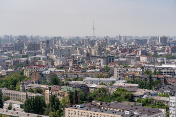 Fototapeta premium Aerial cityscape of Kyiv Ukraine with TV tower and dense urban architecture, panoramic view of city skyline