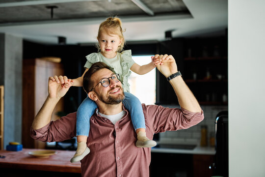 Portrait of father and daughter having fun at home, family life, parenting, love and bonding concepts