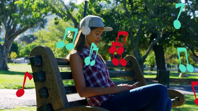 Woman listening to music and tapping phone on park bench causing animated notes moving around her