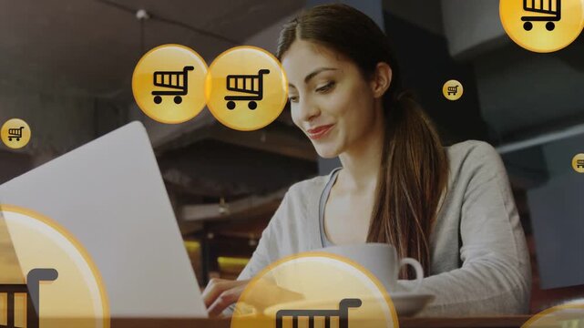 Woman typing on laptop starting yellow cart icons floating over face, keys, showing shopping intent