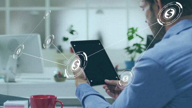 Mid-adult man tapping tablet and animated dollar nodes emerging and linking across desk for finance