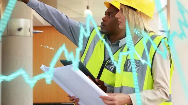 Male pointing, lead donning hardhat reviewing building plans or tablet cyan overlay verifying ceilin