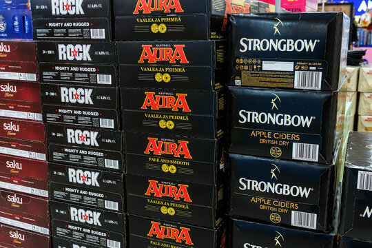 Helsinki, Finland, March 24th 2025. Stacked branded alcoholic beverage cartons with cans of Strongbow apple cider, Alita, Rock, and Saku. Alcohol display at duty free store 
