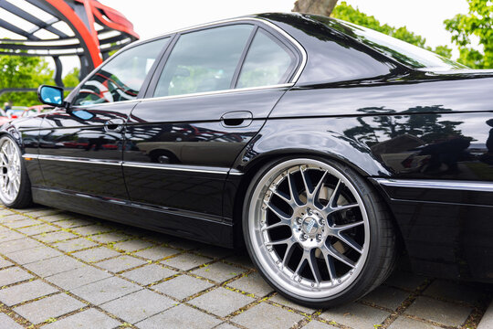 Leipzig, Germany - 9 May, 2026. Closeup rear view of black BMW E38 luxury sedan with chrome details, polished wheels and glossy body reflections parked outdoors. Classic German automotive design
