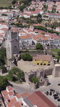 Vertical aerial circling shot of Beja Castle in the town center of Beja, Portugal.