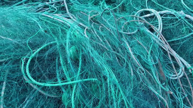 Fishing Nets in Harbour with Boats and Ocean Plastic Pollution