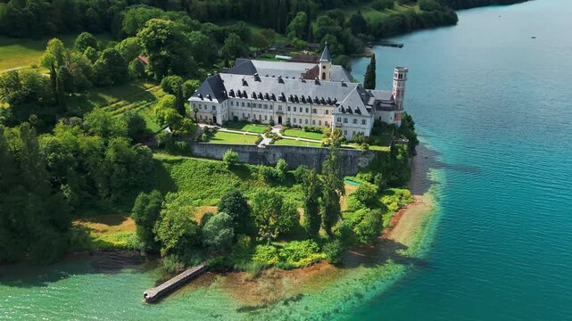 Aerial shot around the Hautecombe Royal Abbey on the shores of the lac du Bourget near Aix les Bains on a sunny day of spring in Savoie departement, Auvergne Rhone Alpes region, France