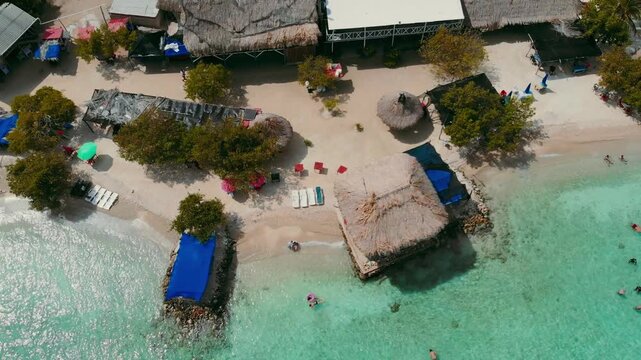 Descending and lateral drone view of Mucura Island beach with crystal clear sea
