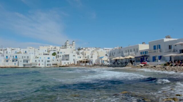 Experience the beauty of Naousa, Paros, Greece, with its crystal clear waters and picturesque white buildings.
