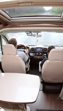 Motorhome interior view while driving along a forest road.