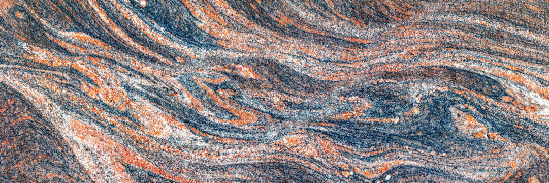 Granite rock with swirling mineral patterns closeup texture
