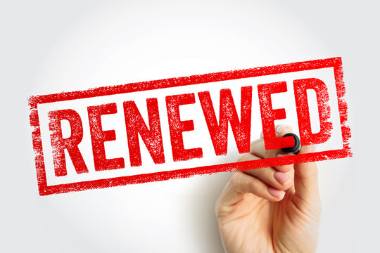 RENEWED text message rubber stamp with marker. Hand holding pen writing on glass. Concept of subscription renewal, contract extension, updating status, and beginning a new cycle