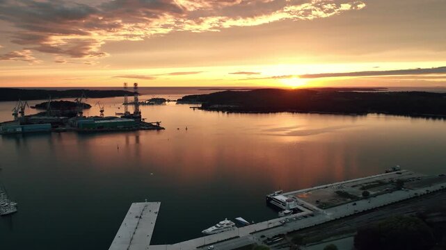 Cinematic aerial drone footage of Pula featuring historic architecture, Adriatic coastline, marina, and Mediterranean atmosphere. Scenic coastal views and ancient Roman heritage .