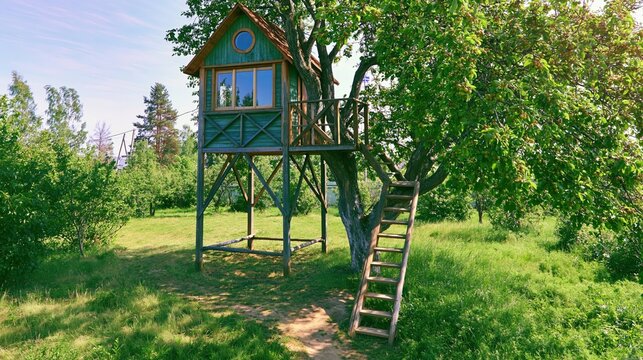 Wooden treehouse in lush garden. Backyard cabin for summer vacation and recreation. Creative wooden architecture for leisure in nature park. Escape from urban life to forest retreat.