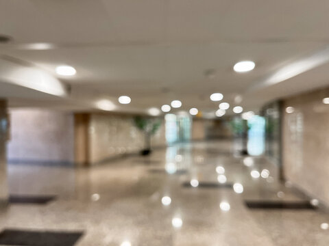 Long hallway with polished floors and recessed lights background
