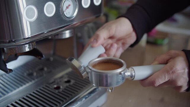 Holding Coffee Tamper above Portafilter in Kitchen