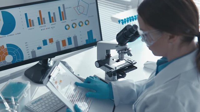 Woman researcher works in high tech lab, examining samples under microscope, reviewing analytics on tablet. Digital charts, laboratory equipment highlight scientific progress, innovation