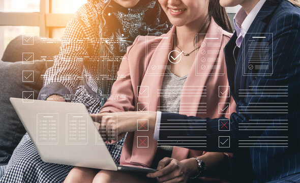Three business professionals engage in a collaborative meeting in a modern office, analyzing data and sharing ideas using a laptop and digital tools for streamlined communication. Cyphers