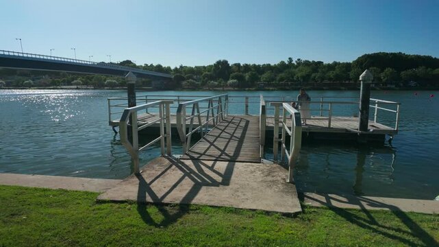 Mother and Child Enjoy a Beautiful Day on a River Dock in Sunny Seville, Spain.