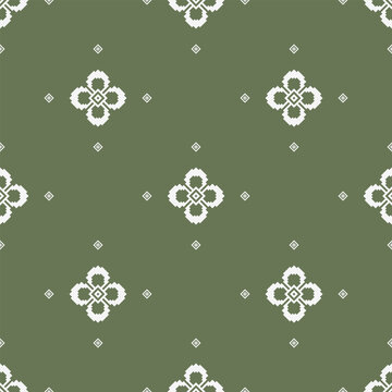 Minimal floral geometric motif with small diamond accents arranged on a muted olive green background. Seamless ethnic-inspired textile pattern with balanced spacing.
