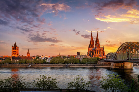 Panoamic view of the cityscape of Cologne, Germany, from the old town along the river Rhine to the Cathedral during a golden sunrise