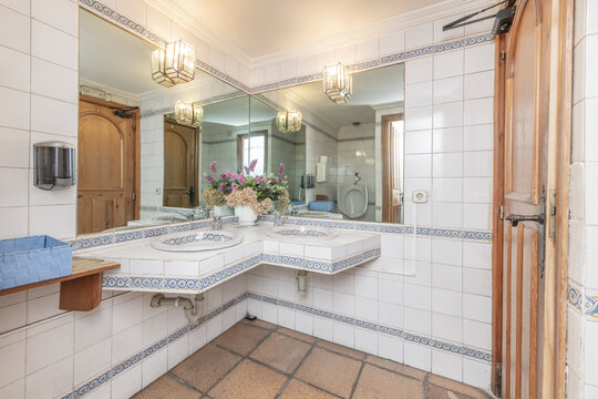 A double vanity with ample interior storage and fabric-covered fronts in neutral tones transforms the master bathroom into a haven of comfort and style