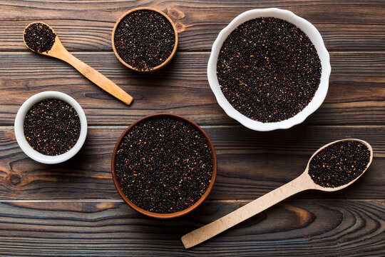quinoa seeds in bowl and spoon on colored background. Healthy kinwa in small bowl. Healthy superfood