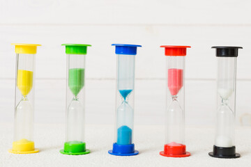 Fototapeta premium hourglass on the table, sand clock as time passing concept for business deadline, copy space