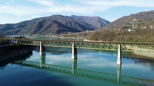 Railway bridge crossing a river, aerial drone view. Steel Railway bridge over the lake. Transportation. 