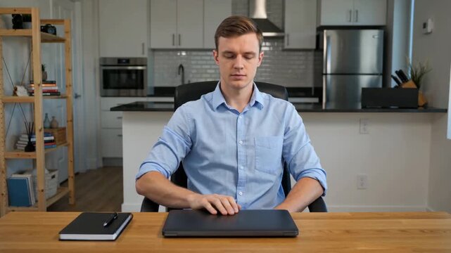 Young Professional Man Closing Laptop After Finishing Work, Focusing on Productivity and Remote
