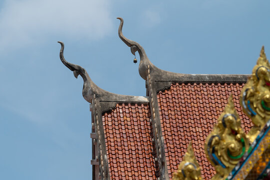 Chofah roof finials on a traditional Thai Buddhist temple roof.