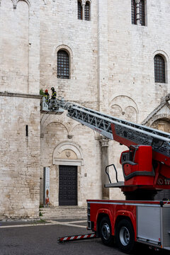 A fire crew removes dirt from the Church of Saint Nicholas in Bari.