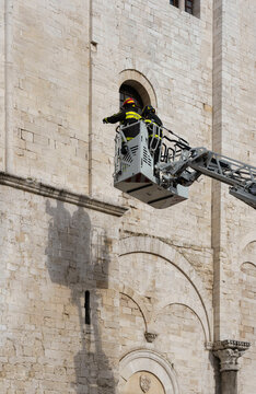 A fire crew removes dirt from the Church of Saint Nicholas in Bari.