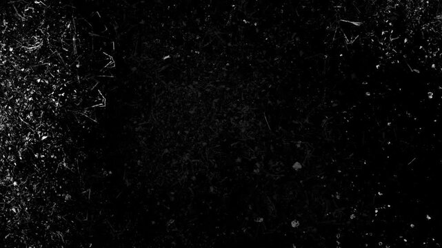 Broken glass shards shattering and cracking overlay effect on black background.