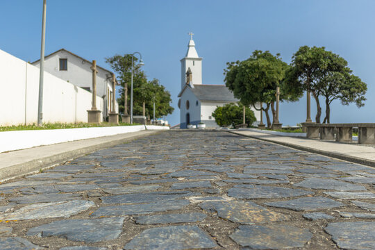 Cobblestone road leading to a white chape in northern Spain