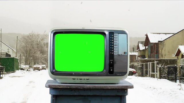 Retro CRT Television Chroma Key Display Outdoors During Snowfall - 4K