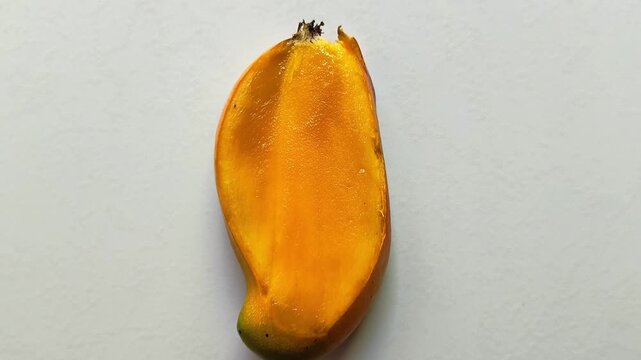 Fresh ripe yellow mango slice Mangifera indica isolated on white background