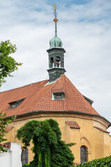 Fototapeta premium Historic church roof and patina bell tower under cloudy sky