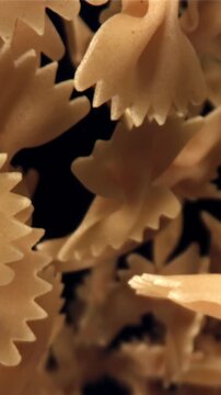 Farfale pasta flies in and falls. Filmed on a high-speed camera at 1000 fps. High quality FullHD footage