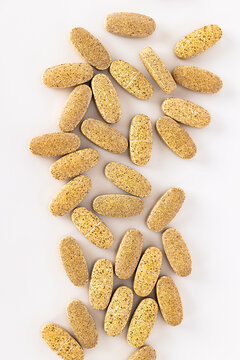 Close up of vitamin supplement tablets isolated on white background. Nutritional supplements and healthcare concept with copy space for text.