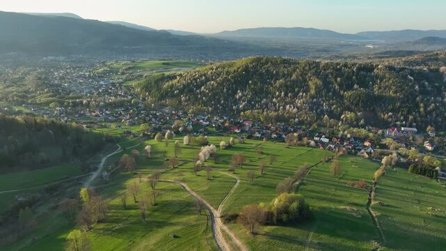 Epic aerial panoramic view from Prusow mountain showing Wegierska Gorka valley, with distant views of Zywiec region, Beskid Slaski and Beskid Maly at sunset.