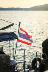 Obraz premium The tricolor flag of Thailand on a vessel, representing Southeast Asian maritime travel, tropical tourism destinations, and patriotic identity.