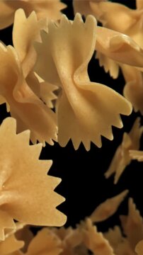 Farfale pasta flies in and falls. Filmed on a high-speed camera at 1000 fps. High quality FullHD footage