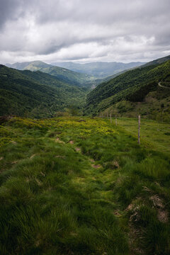 Green mountain landscape cloudy day. View from the top of the mountain to the valley. Ariege Pyrenees France