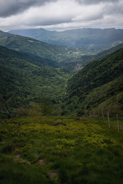 Green mountain landscape cloudy day. View from the top of the mountain to the valley. Ariege Pyrenees France